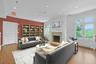 On the second floor, this large and open room has been virtually staged as a sitting room or library. Like so many other rooms in this house, it's cen