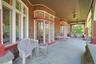 The deep and wide slate front porch is an entertainer's dream. After dinner, the party can move out to this covered space. Pick any of the many seatin