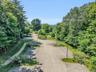 This home has parking unlike any other you will find. The well lit parking lot allows for around forty cars, with additional space elsewhere. Weddings