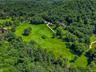 Behind the home is conservation land and we can see the beautiful forest encircling the area.