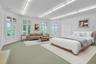 To the left of the sitting room is the possible first bedroom on this floor. Virtually staged, this expansive, bright room has ample space for a bed, 