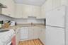The cottage kitchen is a cozy and convenient space. Nearby, there is a full bathroom and a washer/dryer as well.