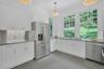 Just next door from the dining room is the chef's kitchen. The view out from the windows is gorgeous and calming, and the stainless appliances and cou