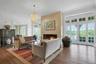 The formal living room, centered around a dramatic wood-burning fireplace, is the first thing to greet you upon entering the home. The original wood f