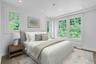 This private rear corner room has beautiful views through the oversized, double-hung windows out to the established trees surrounding the home.