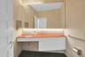 One of two first floor half bathrooms, this sleek, architect designed bathroom is something of a work of art. It feels like you are stepping into a mu