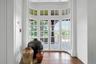 A closer look at the restored original 1800's doors, which open out to the large slate porch and patio beyond. Light shines off of the original hardwo