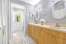 Dual sinks with walk in closet and access to pool area