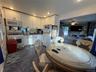Kitchen area featuring white cabinetry, a gas range, and a built-in microwave