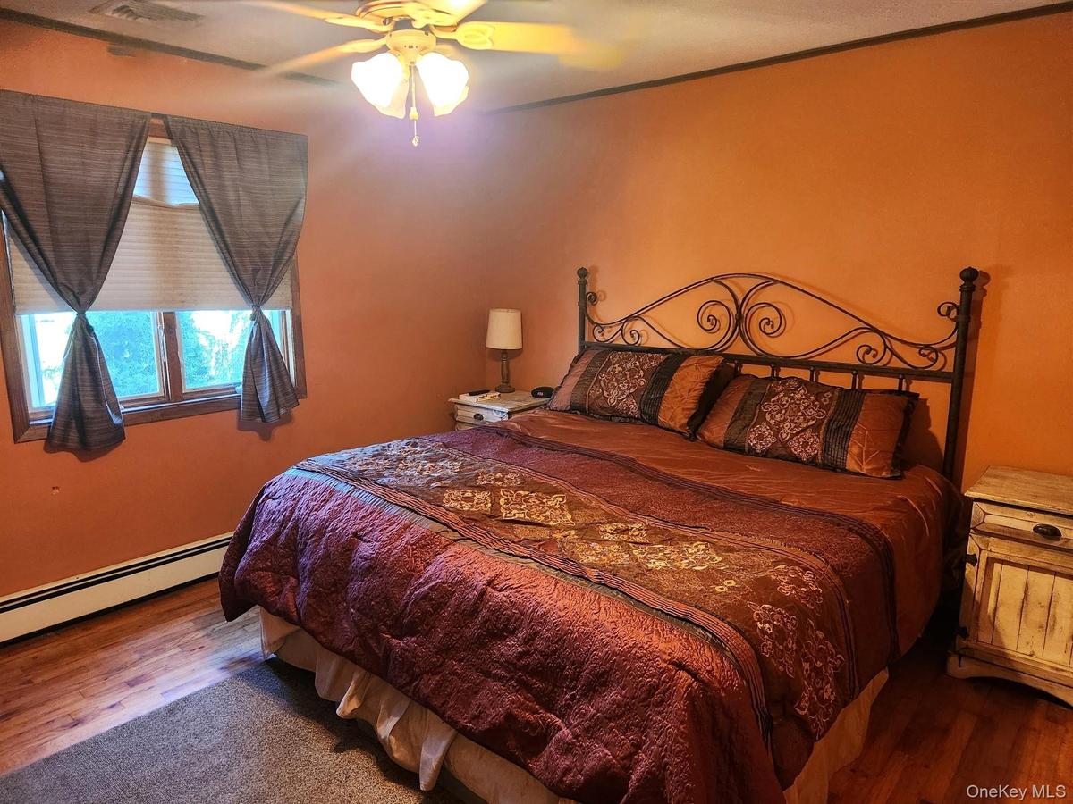 Wood-finish flooring with a ceiling fan light fixture