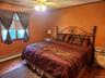Wood-finish flooring with a ceiling fan light fixture