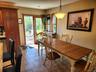 Warm-toned tile flooring, direct outdoor access, built-in cabinetry, recessed lighting, and a suspended ceiling fixture