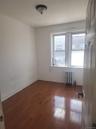 Hardwood flooring and a flush-mount ceiling light fixture