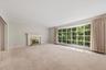 Expansive formal living room with large bow window and wood burning fireplace. Hardwood under carpet.