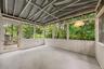Screened porch overlooks wooded backyard