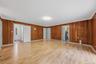 Enormous family room with new laminate floors and SGD to private backyard and patio