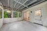Screened porch overlooks wooded backyard