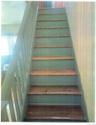Staircase with wooden-finish treads and painted risers