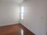 Hardwood flooring, painted walls, single window, recessed lighting, white trim