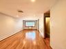Hardwood flooring, recessed lighting, ceiling-mounted light fixture, window with wood trim, and baseboard heating