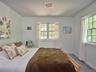Bedroom featuring carpet floors and baseboards