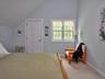 Bedroom with carpet floors and lofted ceiling