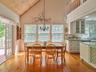 Dining area featuring light wood-style floors, high vaulted ceiling, wooden ceiling, and a chandelier