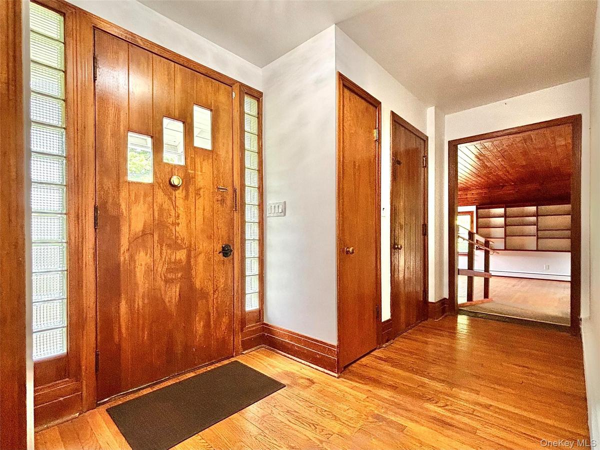 Front Door, foyer, door into garage and hall to living room