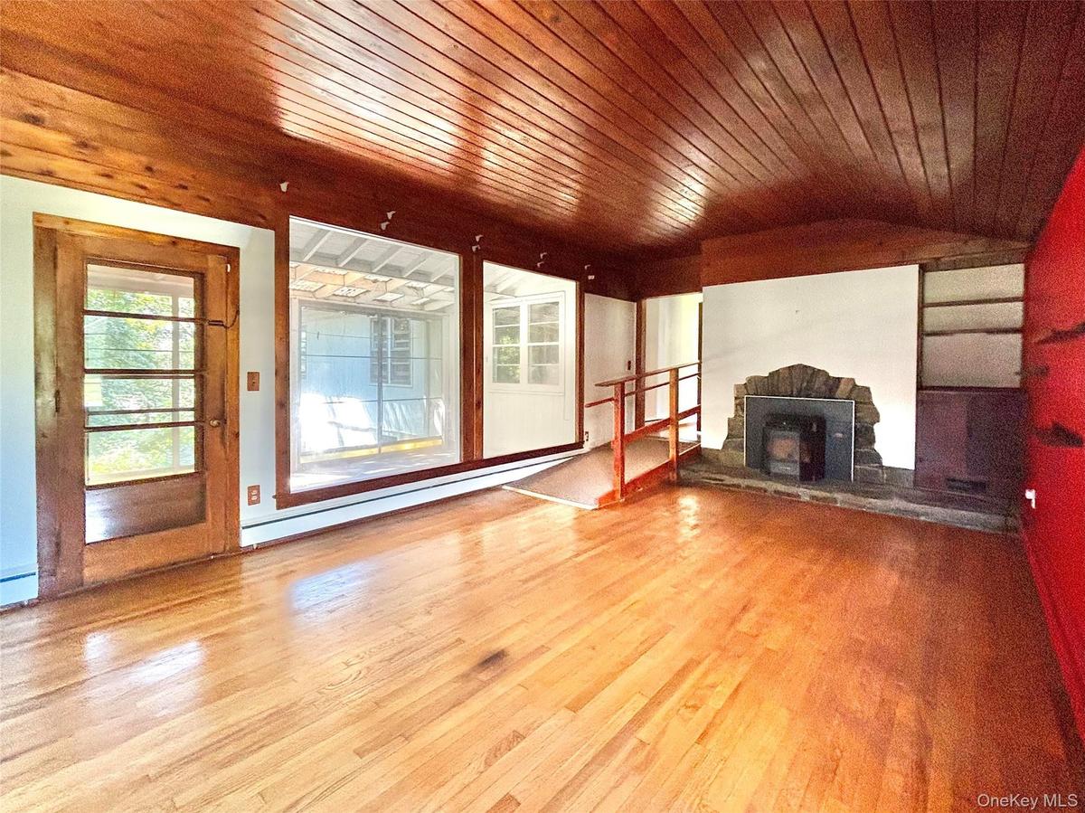 Living Room w fireplace and door to screened porch