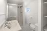 Second floor ceramic tile bathroom with window and linen closet