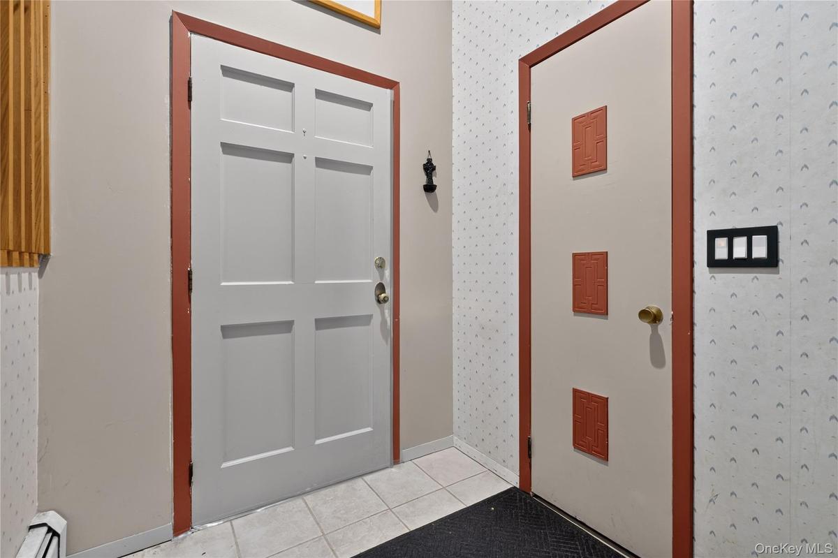 Landing by the front door with a full sized closet