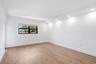 Recessed lighting, wood-finish flooring, white walls, black-framed window, window blinds