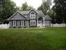 Charming, modern colonial features natural setting and all the conveniences.