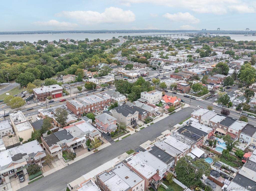 Aerial view of property and surrounding area with a large body of water
