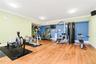 Expansive room featuring wood-finish flooring, recessed lighting, crown molding, and a light green and blue wall color scheme