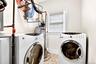 Laundry area with tile flooring and a window