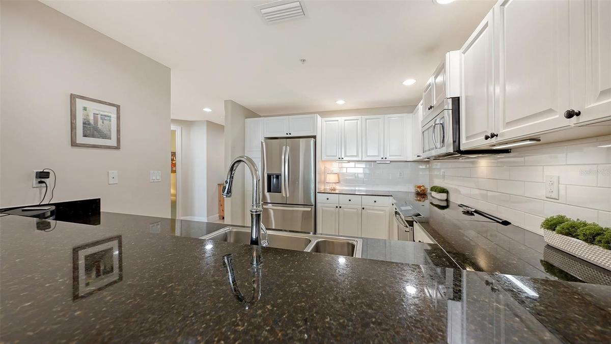 Black Granite CountersWhite Tile Backsplash