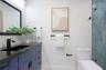The Primary bathroom is functional and features designer touches. A tube skylight brings in natural light.
