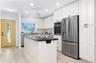 An entry breaks up the home. The kitchen has plenty of storage and counter space.