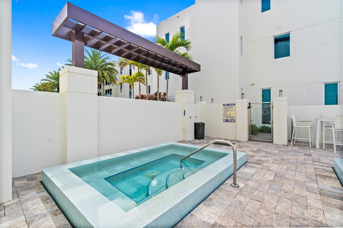 221 Shore Ct Community Pool. A remarkable luxury townhome rental that redefines upscale living in the heart of Lauderdale By The Sea. This beautifully