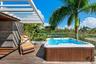 Private hot-tub area with shaded seating — perfect for evening relaxation and entertaining guests outdoors.