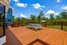 Comfortable exterior deck space offering a quiet retreat with views of the expansive acreage.