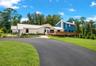 Welcome to a spacious rural property offering privacy, open land, and multiple structures including a residence and detached garage buildings.