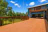 Expansive two-story wraparound deck spanning three sides of the home, ideal for outdoor entertaining and scenic enjoyment.