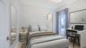 Guest suite with a dedicated workspace and direct access to the residence’s outdoor living. VIRTUALLY STAGED.