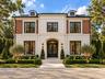 Front elevation of 250 W Reading Way in Winter Park, featuring a two-story design and arched entry.