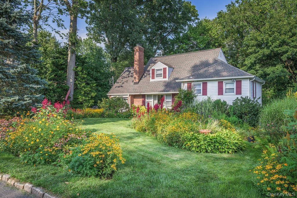 Front of home with beautiful front yard landscaping