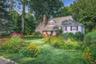Front of home with beautiful front yard landscaping