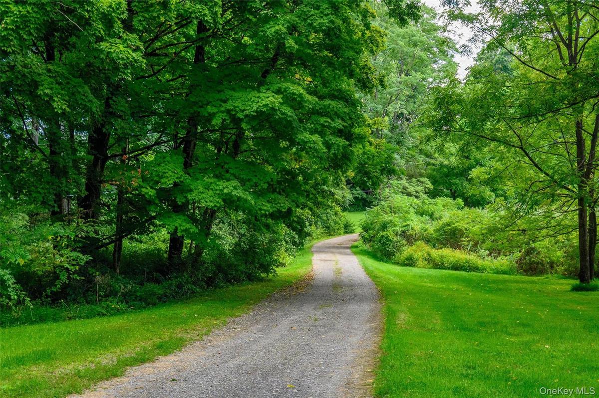 Long private driveway leads to home