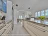 Volume Ceilings, French Doors, Wall of Windows and Dormers bring Natural Light into the Kitchen all day